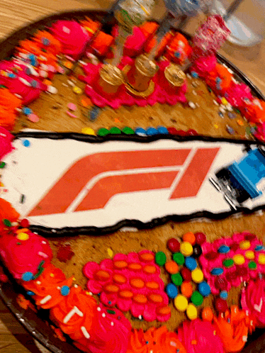a cake with a f1 logo on it and sprinkles