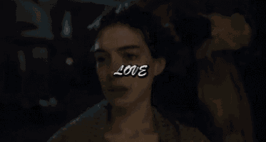 a close up of a woman 's face with the word love on it