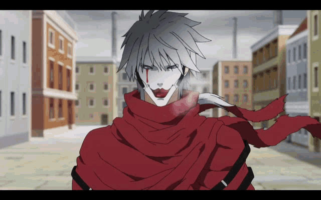 a man with a red scarf around his neck is standing in a city