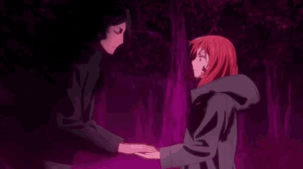 a man and a woman are holding hands in a forest in a purple light .