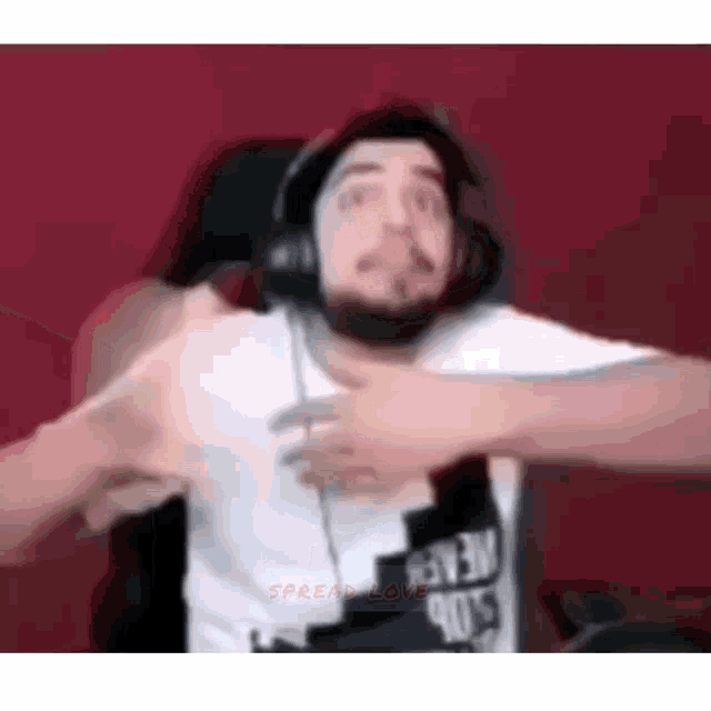 a man wearing headphones is sitting in a chair .