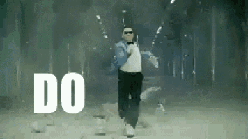 a man is dancing in a room with the words `` do '' written on the floor .