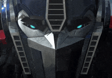 a close up of the face of a robot with blue eyes