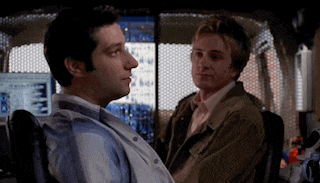 a man in a wheelchair talking to another man