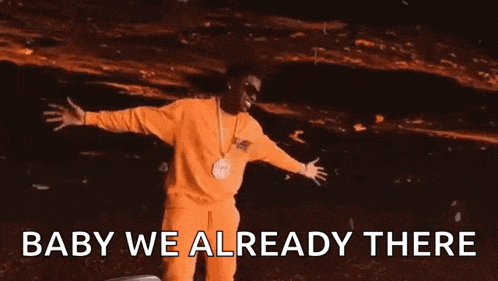 a man in yellow pants is dancing with the words baby we already there above him
