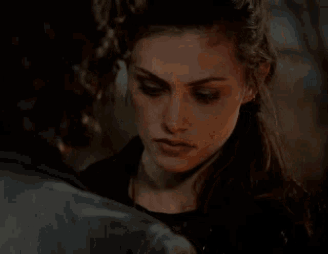 a close up of a woman 's face looking at a man .