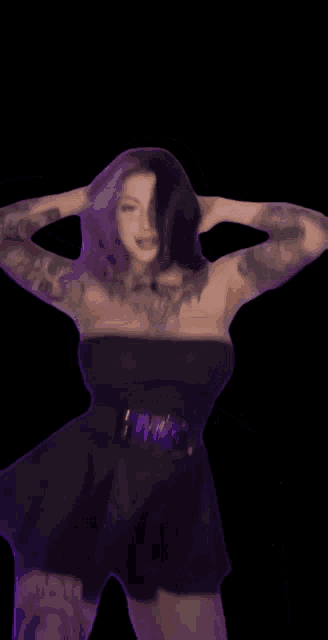 a woman with tattoos on her arms is wearing a black strapless dress