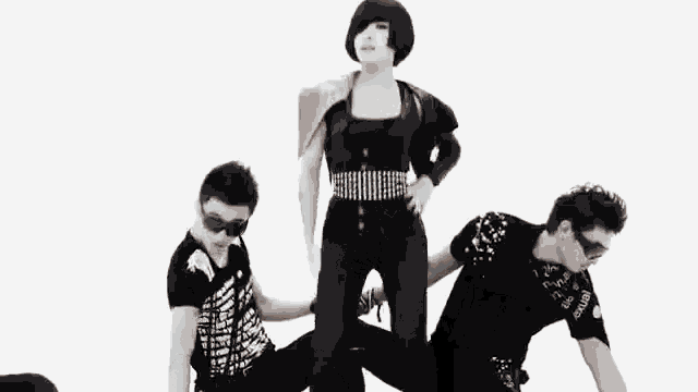 a woman is standing on top of a man and a woman is sitting on a man 's lap .