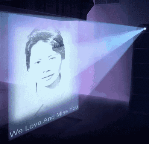 a projector projecting a picture of a woman with the words we love and miss you