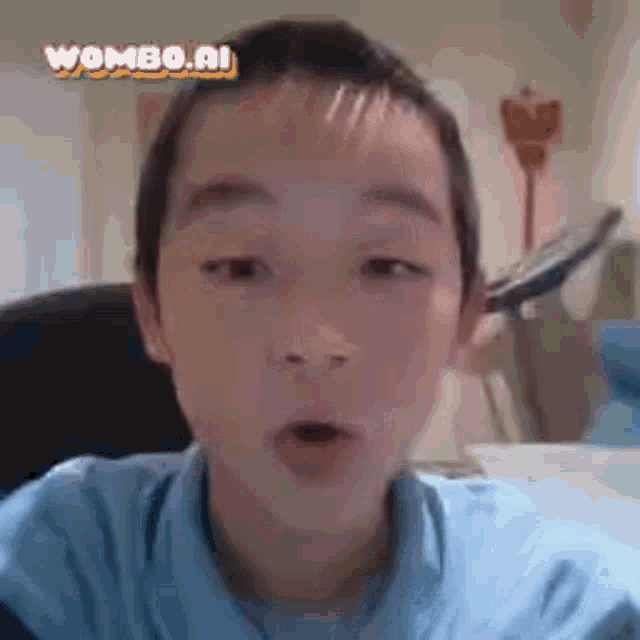 a young boy in a blue shirt is making a funny face while looking at the camera .