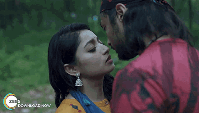 a man and a woman kissing with the words zee5 download now visible