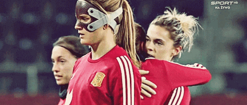 a soccer player wearing a mask with the letter x on her face