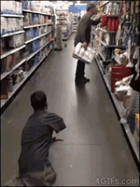 a man is kneeling down in a grocery store aisle while another man looks at a bag