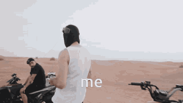 a man wearing a ski mask is riding a four wheeler in the desert and the words me are visible