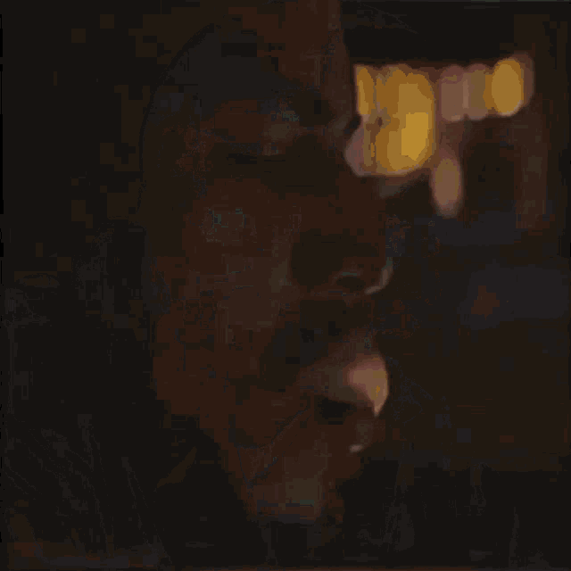 a man wearing a cross necklace is looking at the camera