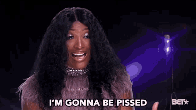 a woman is saying i 'm gonna be pissed in front of a microphone
