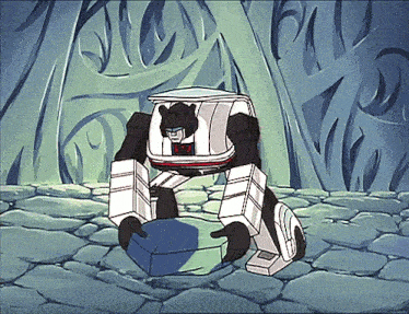 a cartoon of a transformer holding a box with the letter t on it