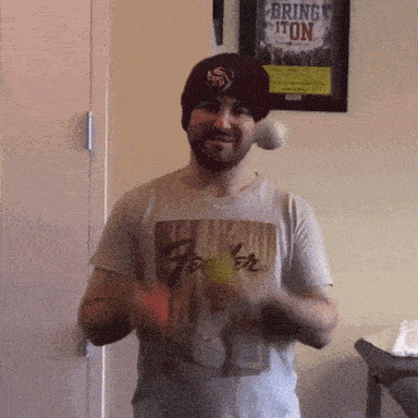 a man wearing a beanie and a t-shirt that says " bring it on "