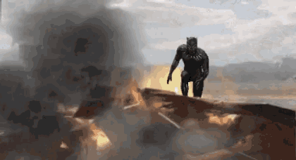 a black panther is standing on top of a building that is on fire