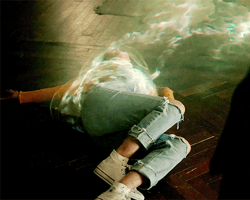 a person laying on the floor with their legs crossed and their converse shoes on