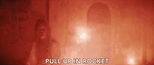 a man is standing in a dark room with the words pull up in rocket written above him