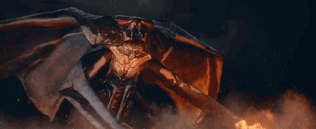 a monster with wings is surrounded by fire
