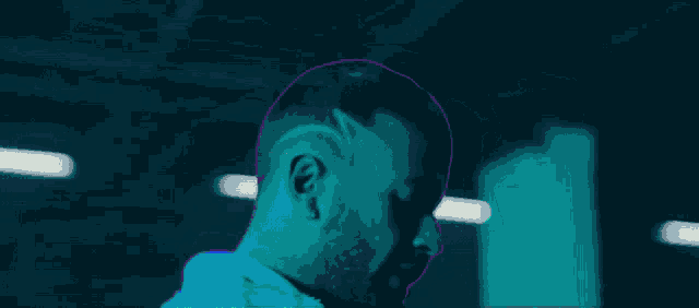 a man with a shaved head has a letter m on it