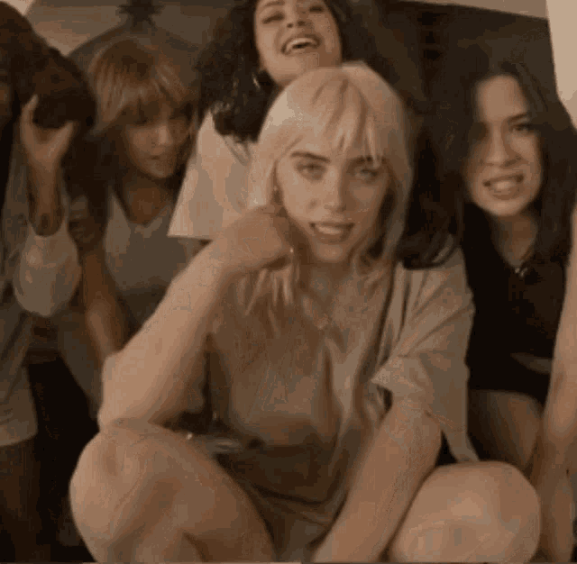 a group of women are posing for a picture and one of them is smiling