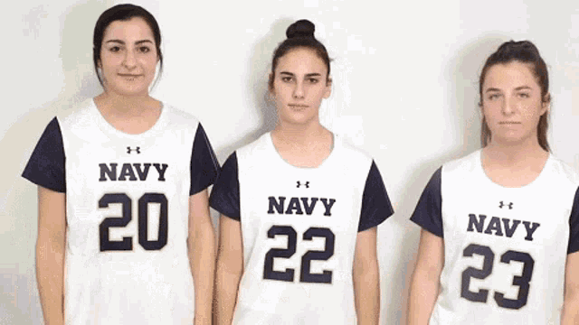 three girls wearing under armour navy jerseys
