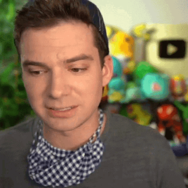 a man wearing a bandana around his neck is looking at the camera