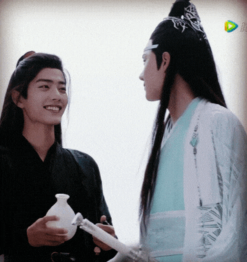 two men are standing next to each other and smiling