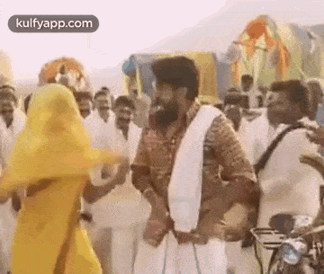 a man and a woman are dancing together in front of a crowd of people .