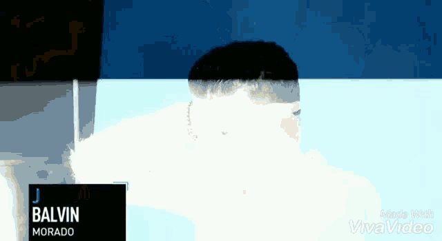 a man is taking a bath in a bathtub with the name j balvin on the bottom