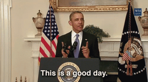 barack obama stands at a podium with the words this is a good day on it
