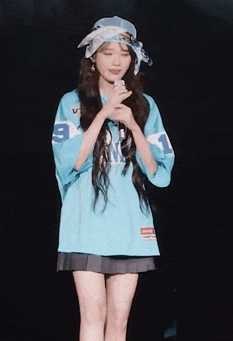 a woman wearing a blue jersey with the number 1 on it