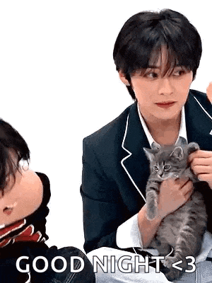 a man is holding a kitten in his arms and says `` good night < 3 '' .