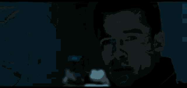 a man is holding a gun in his hand in a dark room