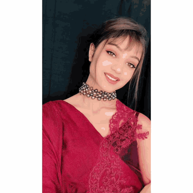 a woman wearing a choker and a red top