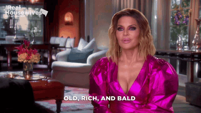 a woman in a pink dress says old rich and bald in a living room