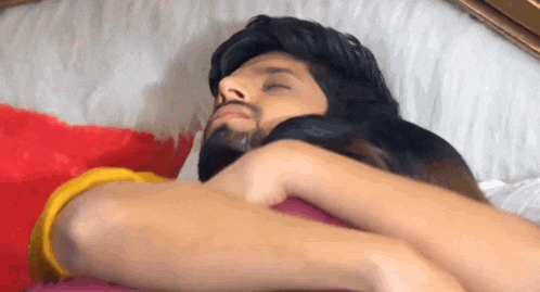 a man and a woman are hugging each other in bed .