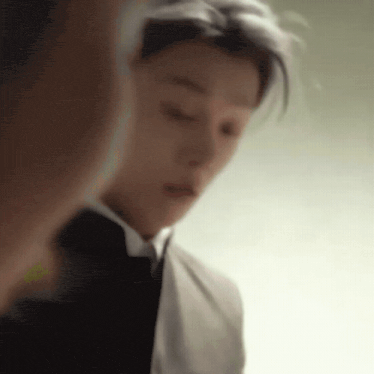 a man in a suit and tie is taking a selfie .