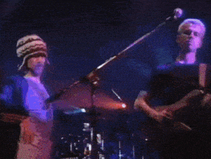 a man is playing a guitar in front of a drum set that says yamaha