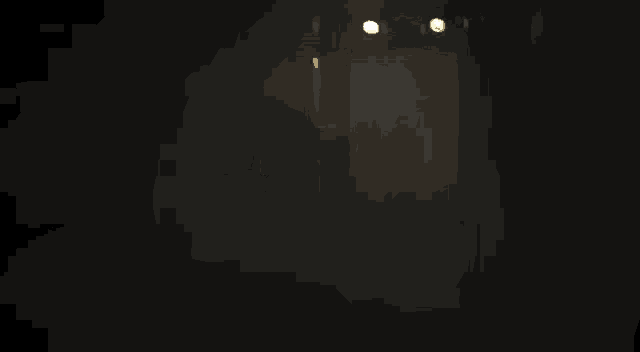 a person is holding a gun with a flame coming out of it in a dark room