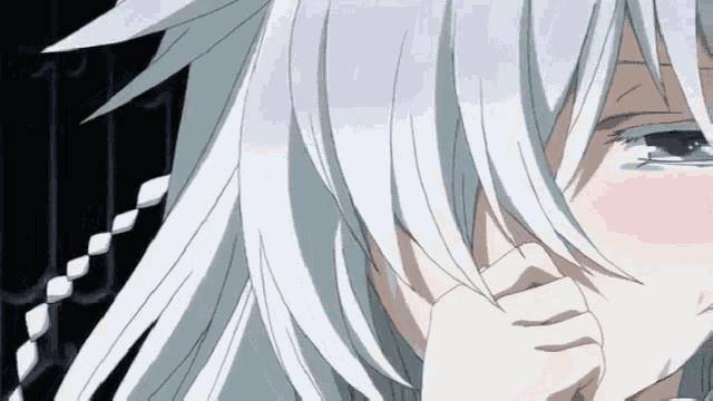 a close up of a person with white hair covering their face