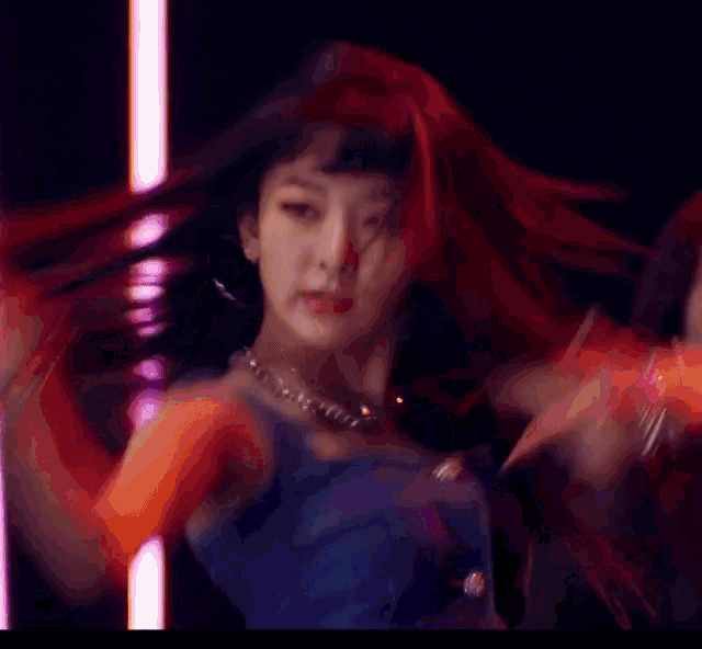 a woman in a denim crop top is dancing in a room with mannequins .