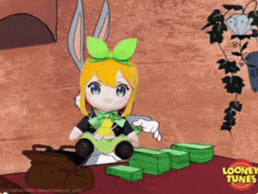 a stuffed bunny is sitting next to a pile of money and a looney tunes logo