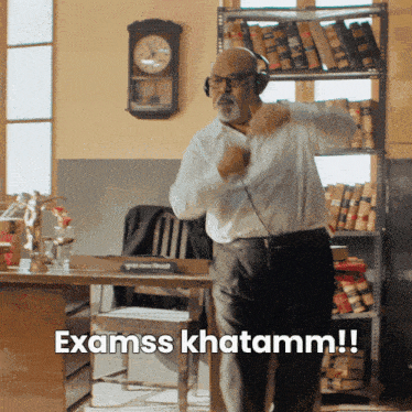 a man wearing headphones says examss khatamm in a room