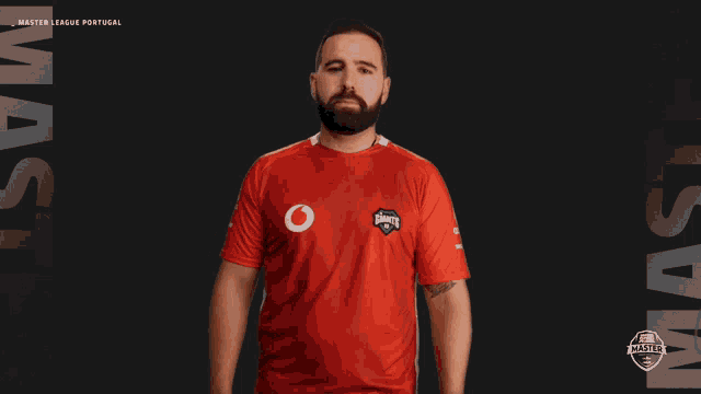 a man wearing a red shirt that says master league portugal on it