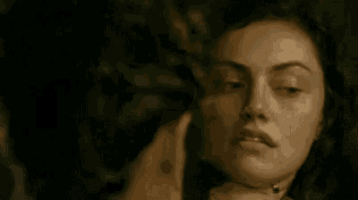 a close up of a man 's face in a dark room with his eyes closed .