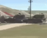 a couple of tanks are parked next to each other on a grassy field .